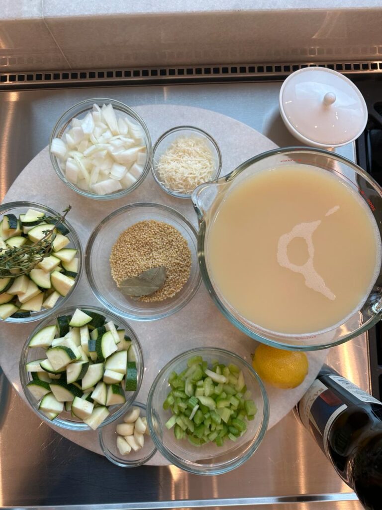 Ingredients for Nonna's Penicillin Soup: onion, garlic, celery, zucchini, thyme, pastina, bay leaf, broth, lemon, Parmigiano-Reggiano and olive oil